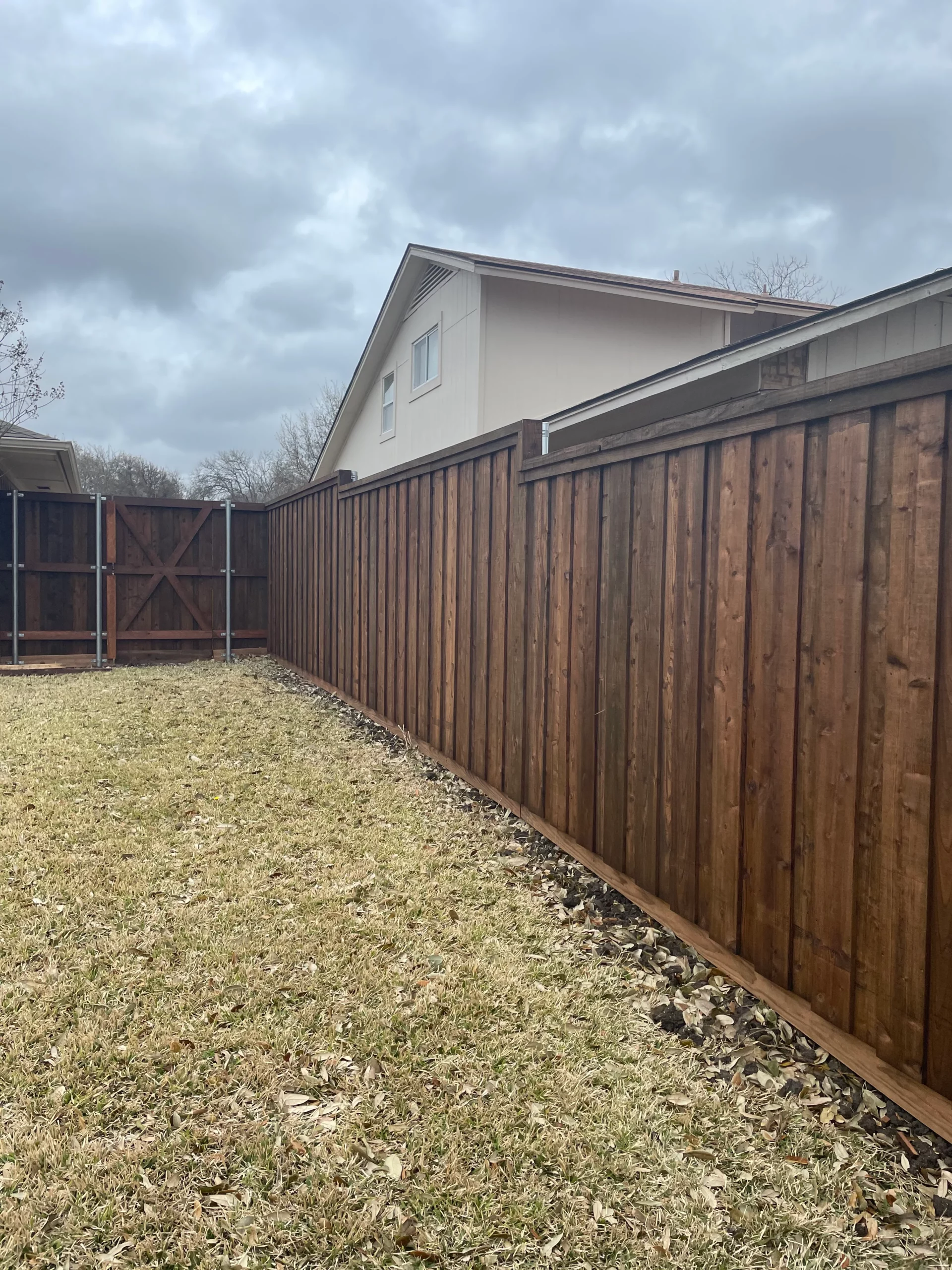 A Cedar Board on Board Fence with Top Cap and Double Trim